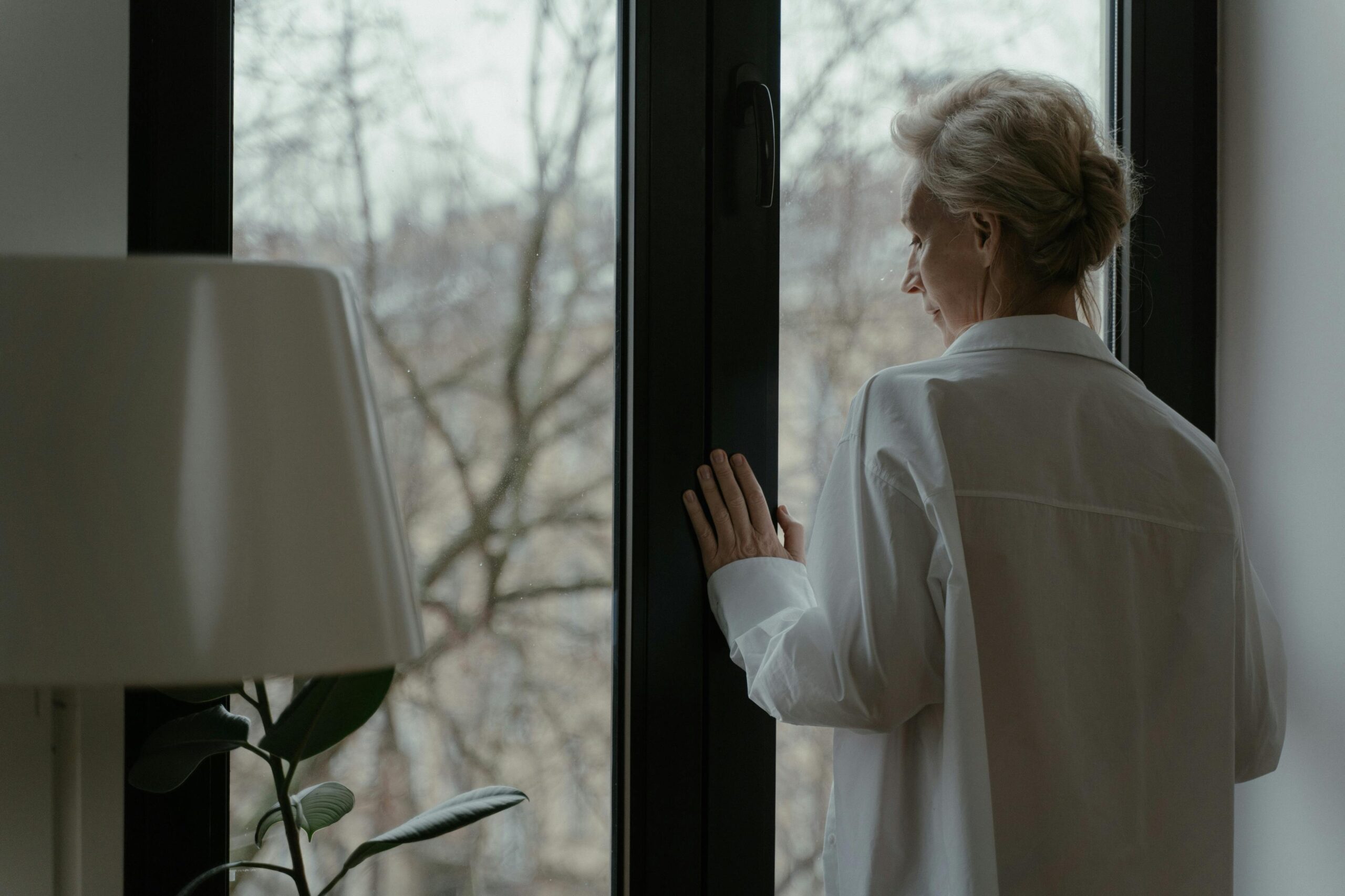 Woman looking out window