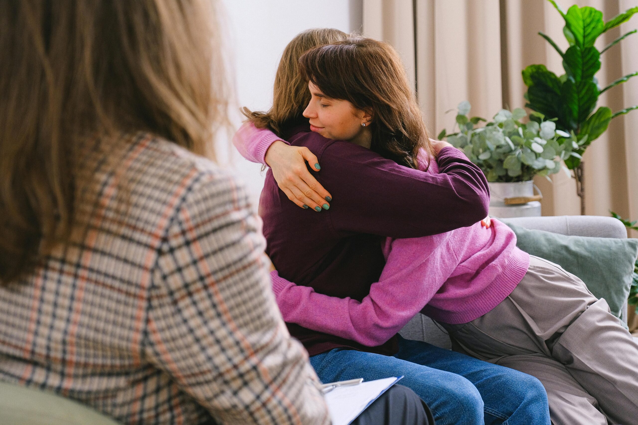 Women hugging therapy session